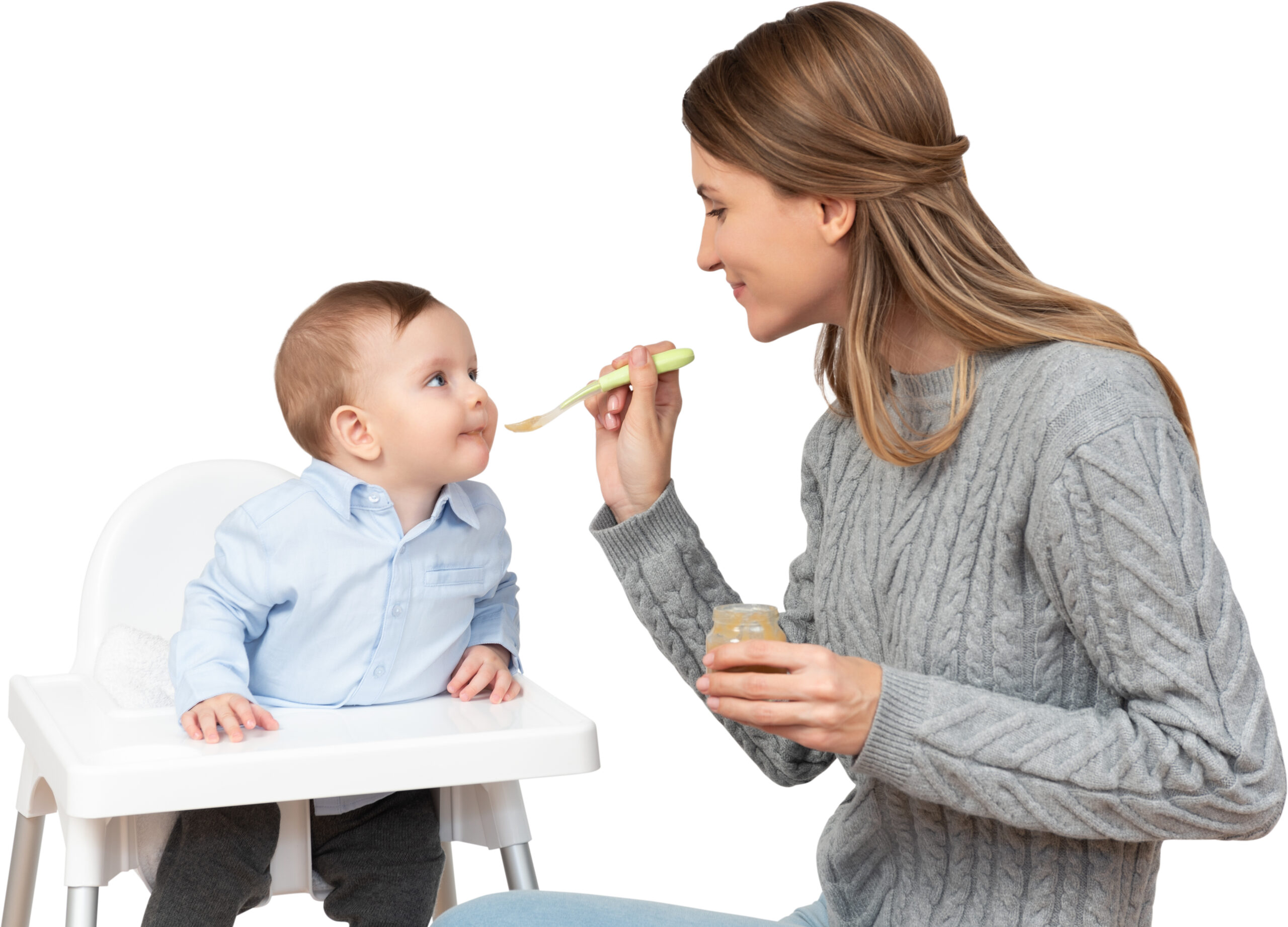a woman feeding a baby with a spoon