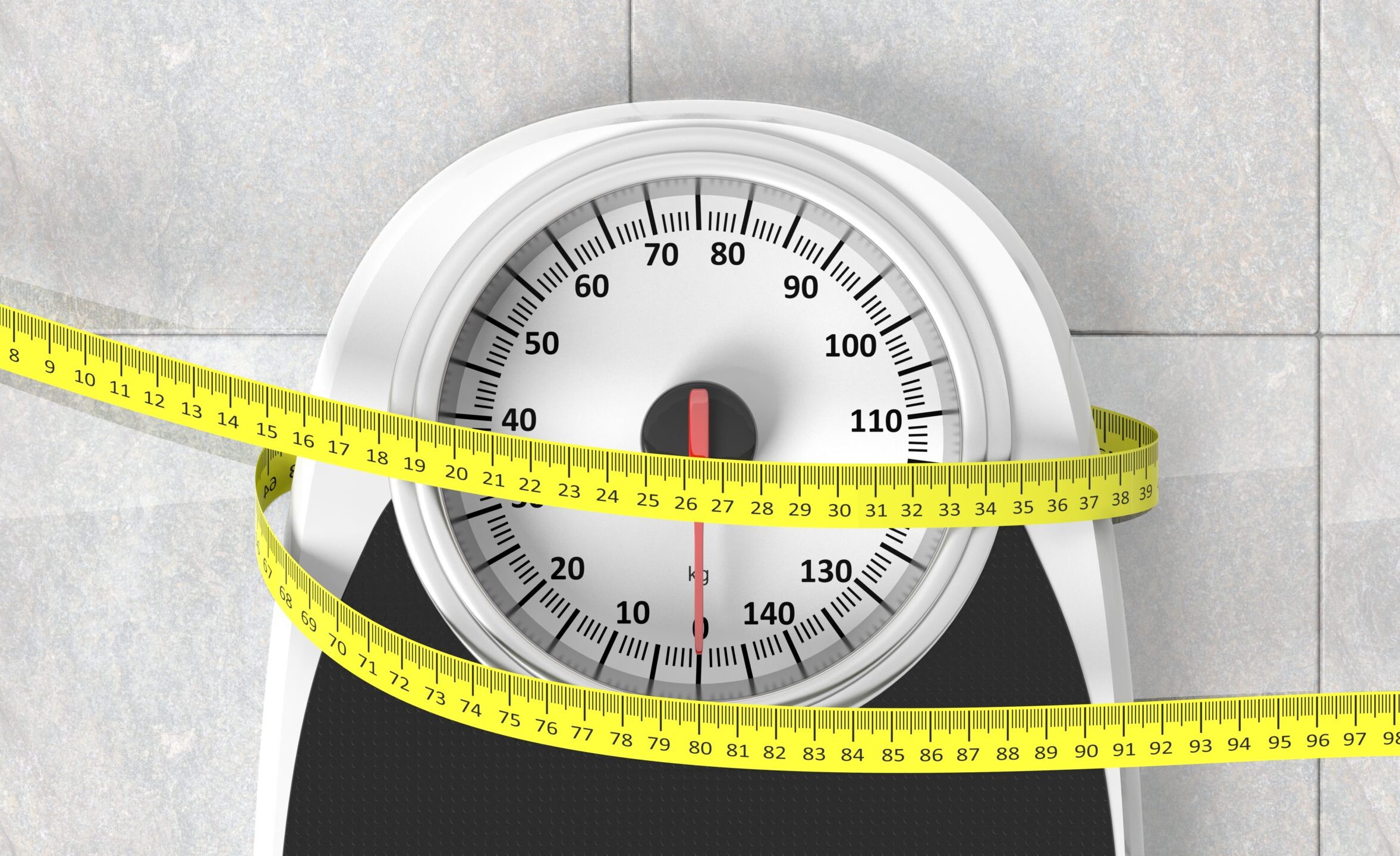 Bathroom scale with measuring tape closeup on bathroom floor